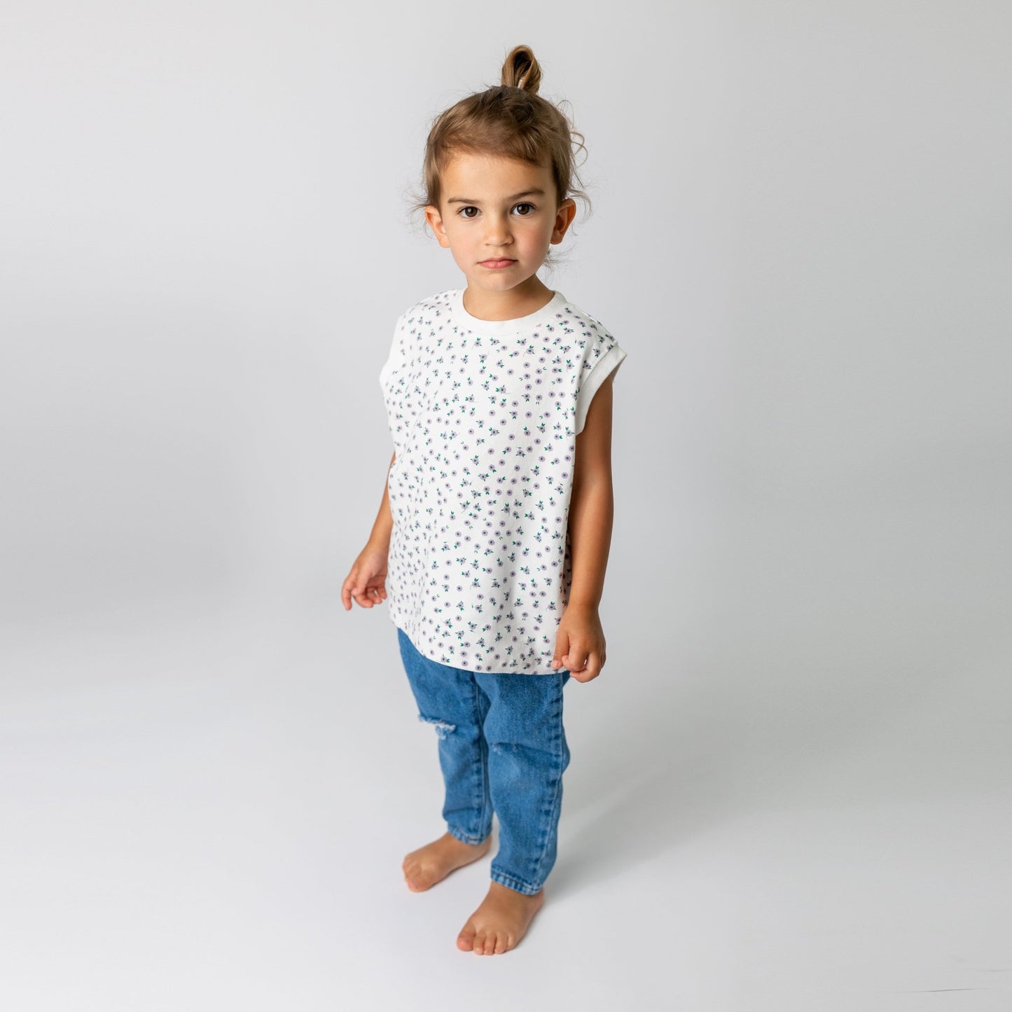 Child modeling white daisy soft cotton t-shirt in cool oversized style - boutique children's clothing