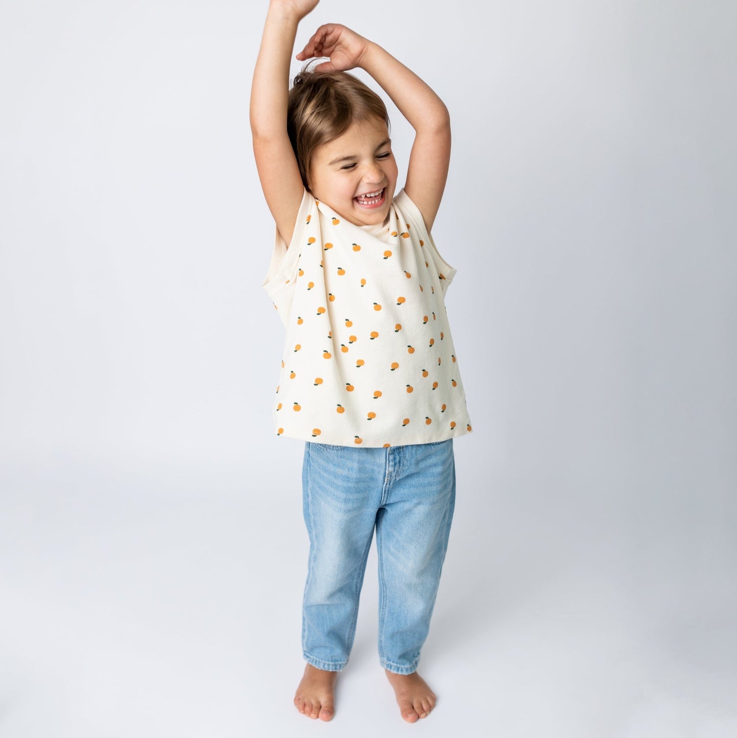 Child wearing ivory mandarin sleeveless-shirt in loose comfortable fit - quality toddler tee