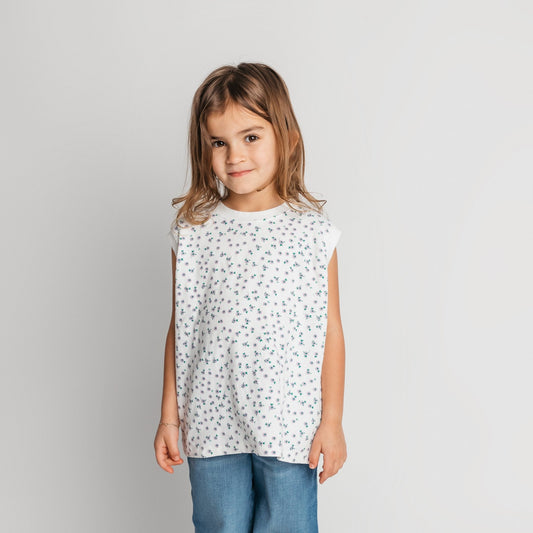 Toddler wearing super soft quality cotton white daisy sleeveless shirt in relaxed oversized fit - quality children's clothing
