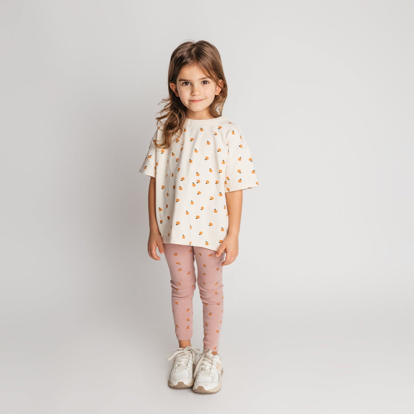 Child modeling ivory mandarin tee in soft cotton with a cool oversized style