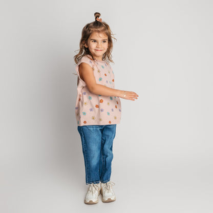 Toddler wearing soft cotton pink daisy sleeveless shirt in relaxed oversized fit - comfortable quality children's clothing