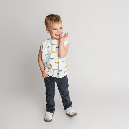 Child modeling white soft cotton t-shirt in cool dino print with an oversized style 