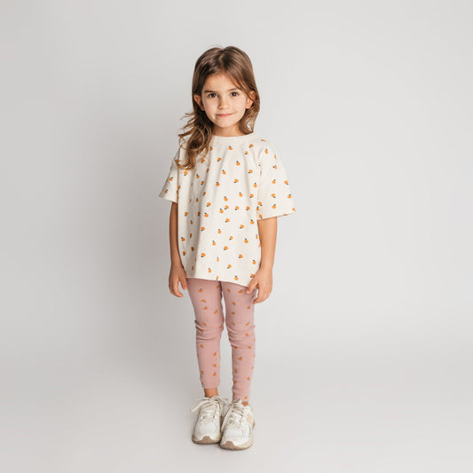 Child modeling ivory mandarin tee in soft cotton with a cool oversized style